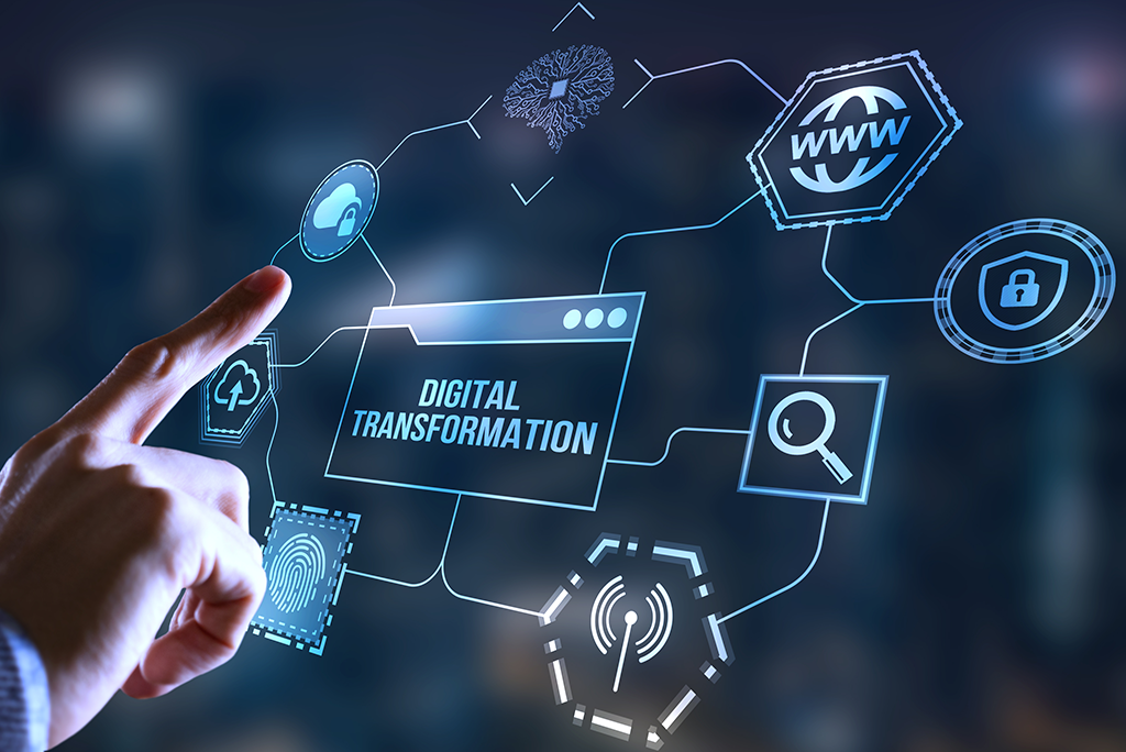 A hand with a finger pressing a hologram screen with different digital items, the middle of the hologram saying "digital transformation."